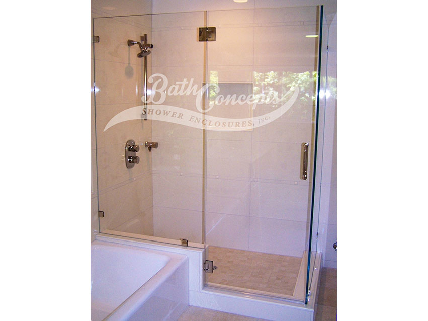 22 Frameless corner enclosure with an inline & return stationary panel with the door hinged off the inline stationary panel  CLEAR GLASS CHROME HARDWARE 1193 - 1293
